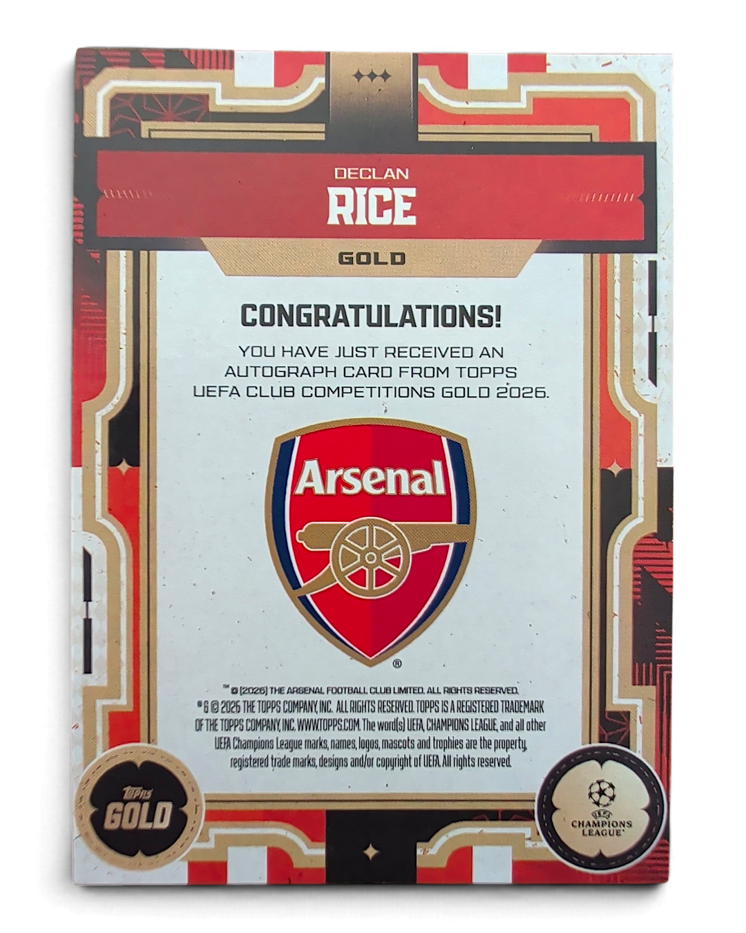 Topps UCC Gold 2025/26 Declan Rice Gold Auto Orange 16/25 autograph card, back, with Arsenal crest