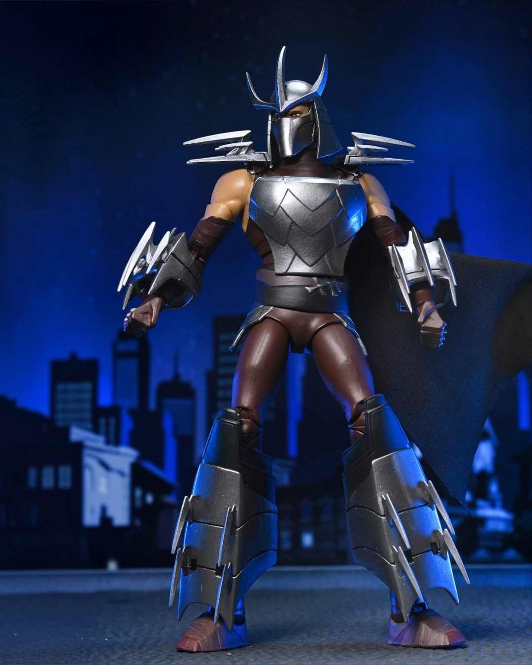 VaultifyUK NECA TMNT 2012 Shredder action figure with metallic armor, fabric cape, and sharp blade attachments