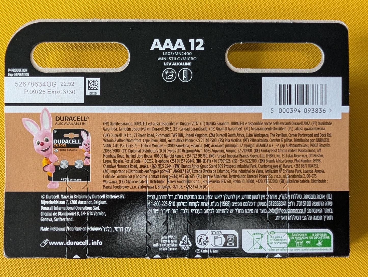 Box of AAA batteries with visible branding on a yellow background