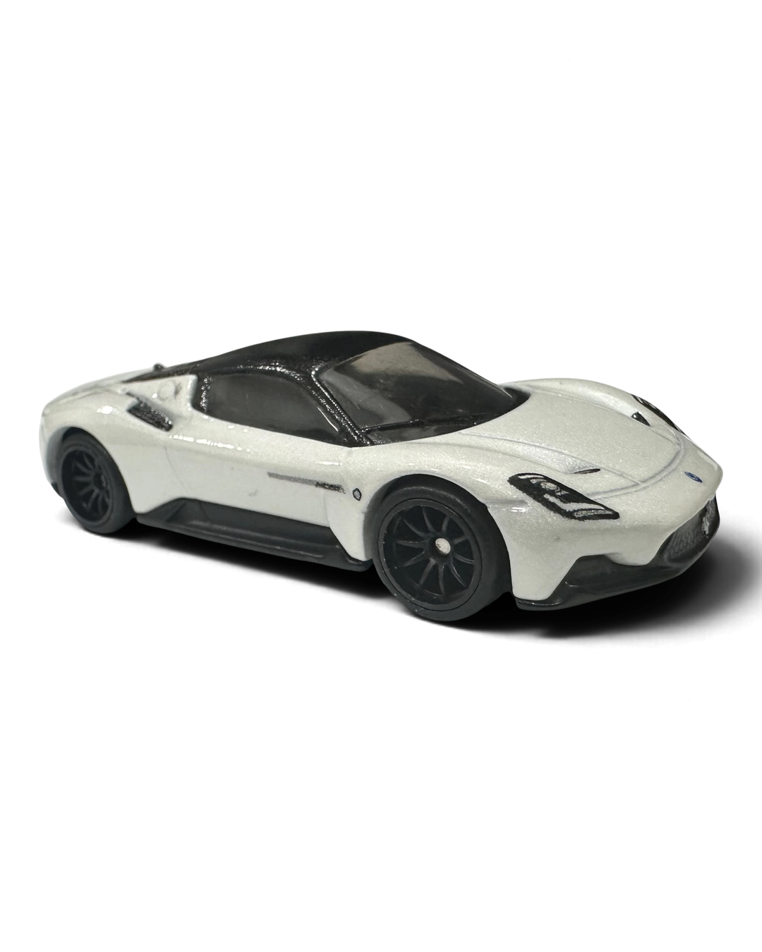 VaultifyUK Hot Wheels Premium Maserati MC20 die-cast car in white with black roof and wheels, 1:64 scale model.