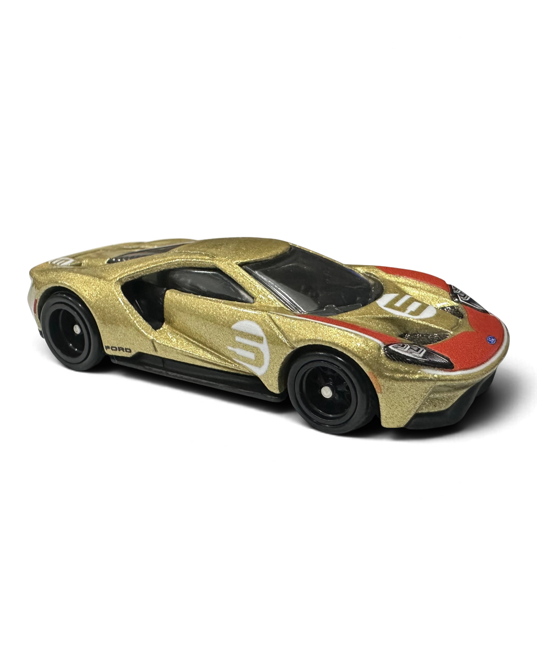 VaultifyUK Hot Wheels Premium 17 Ford GT die-cast car in gold with Holman Moody livery and Real Riders tires.