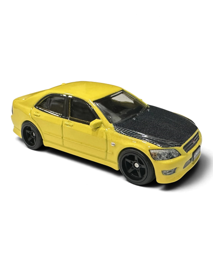 VaultifyUK Hot Wheels Premium 1:64 scale yellow Toyota Altezza die-cast car with black carbon-effect bonnet.