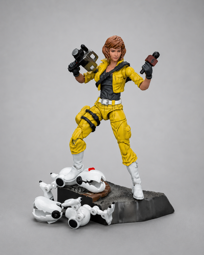JoyToy TMNT April O’Neil figure posed with camera and microphone on a scenic base with damaged robot accessories