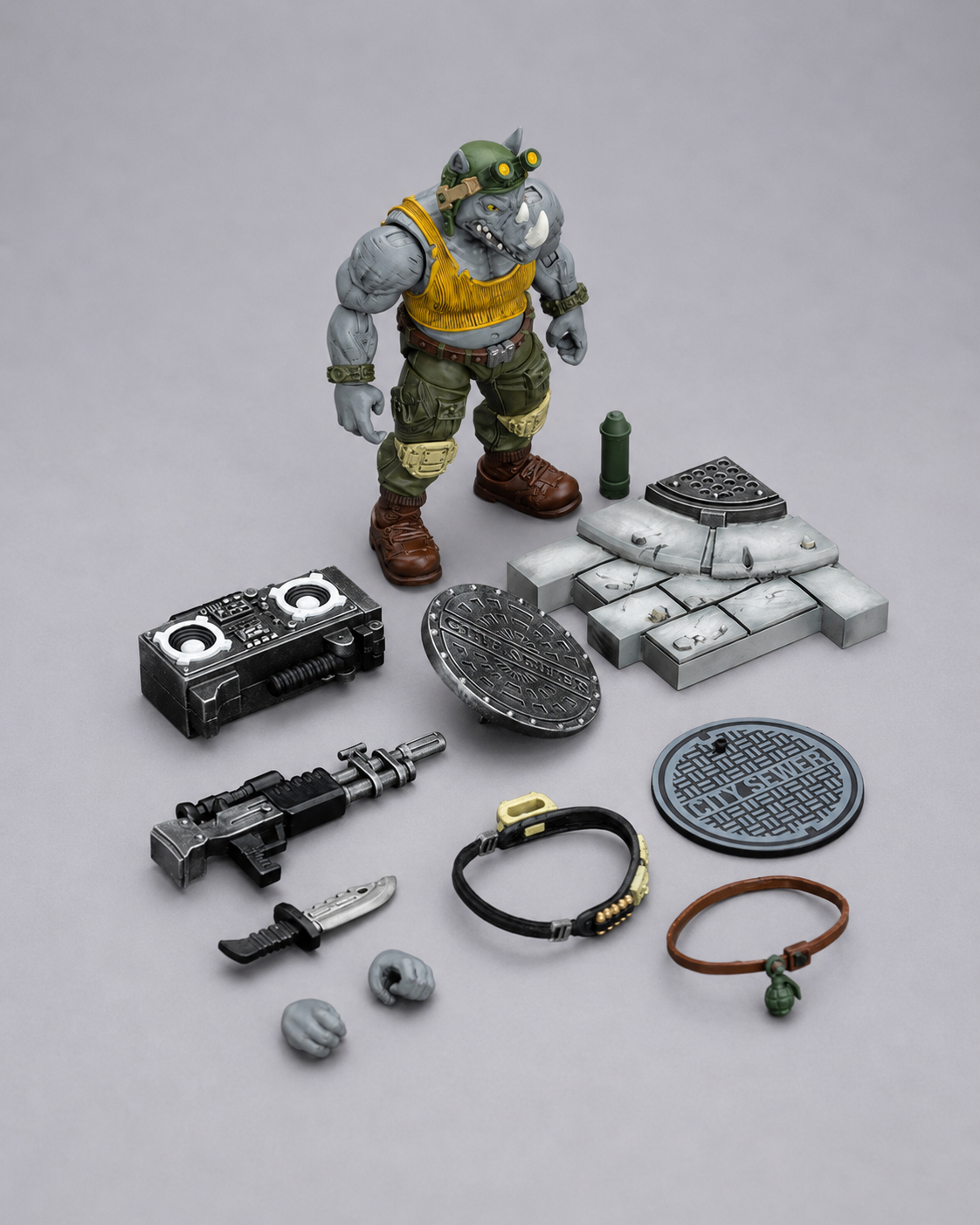 JoyToy TMNT Rocksteady action figure displayed with rifle, knife, boombox, sewer base, interchangeable hands and accessories
