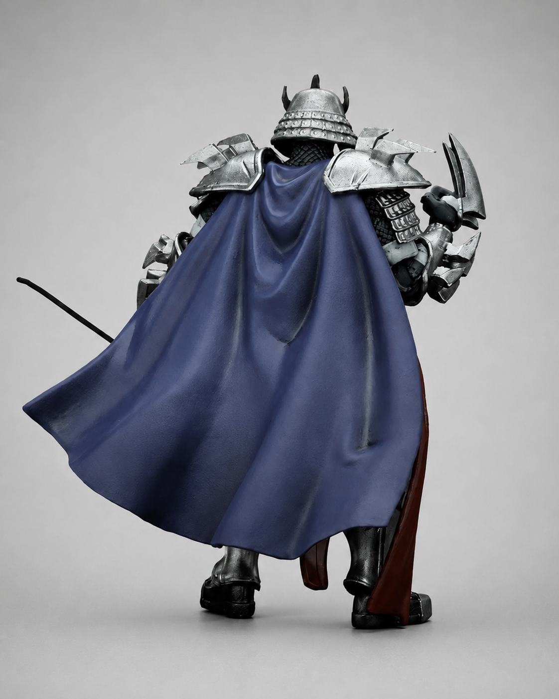 Rear view of the JoyToy TMNT Shredder action figure showing the blue cape, helmet and shoulder armour