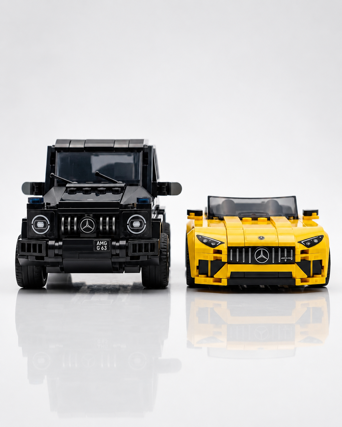 Built LEGO Speed Champions Mercedes-AMG G 63 SUV and Mercedes-AMG SL 63 roadster displayed side by side.