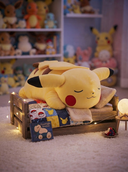 Sleeping Pikachu 18-inch plush displayed on a cosy Pokémon-themed bed