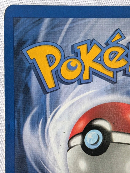 Close-up of a Pokémon trading card with the Pokémon logo and ball design.