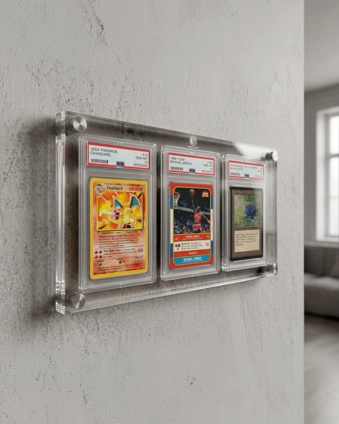 VaultifyUK 3-slab acrylic wall display frame holding three graded trading card slabs with metal standoff mounts.