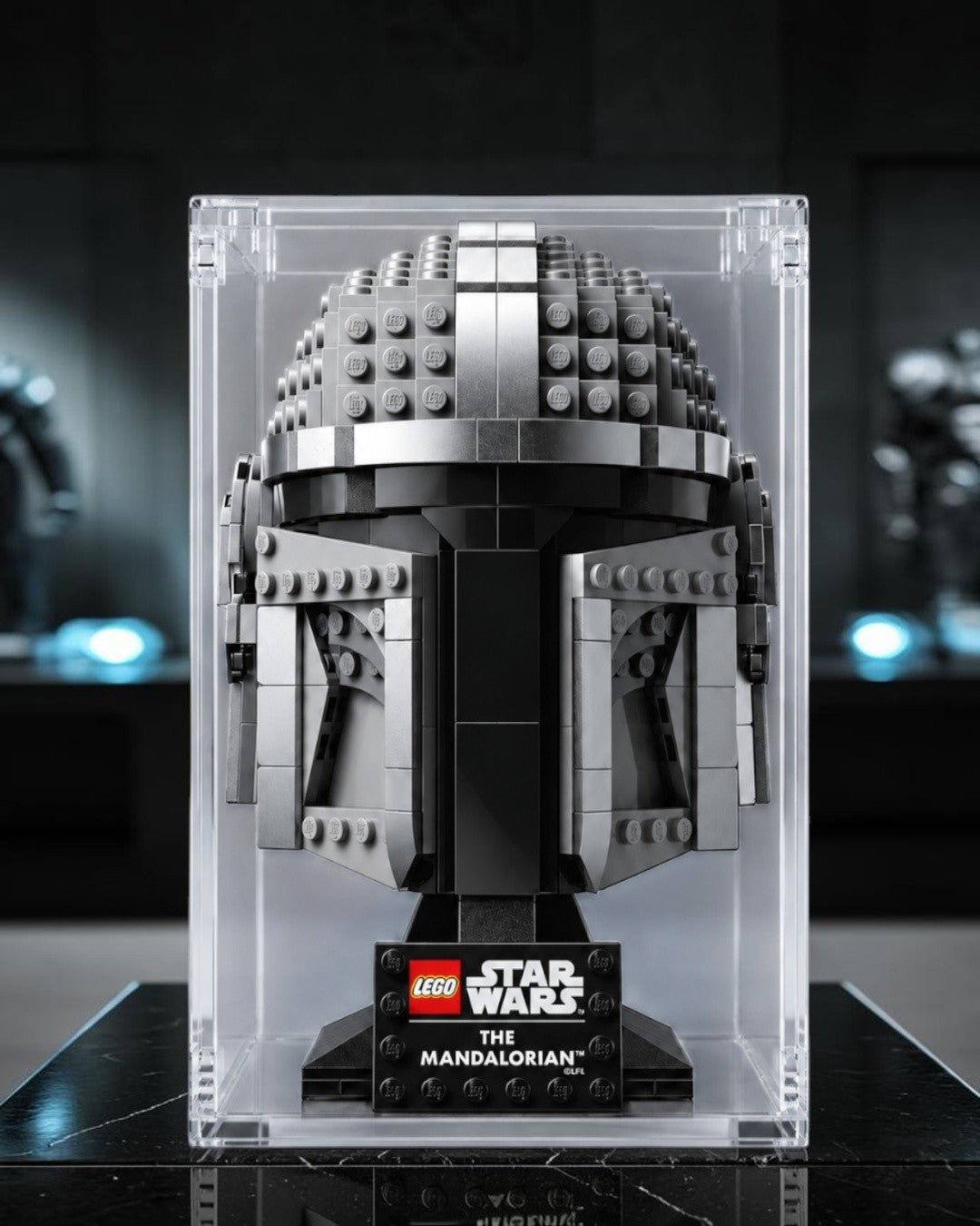 VaultifyUK clear acrylic display case protecting a grey LEGO Star Wars Mandalorian helmet collectible figure