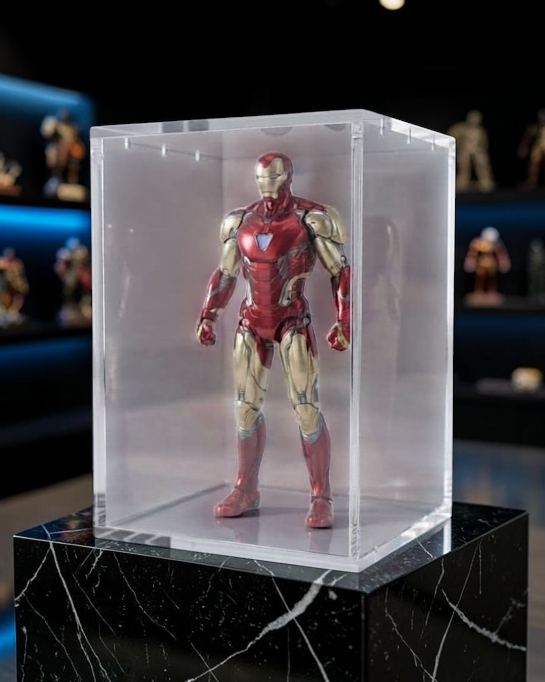 VaultifyUK clear acrylic display case showcasing a red and gold Iron Man action figure on a wooden table