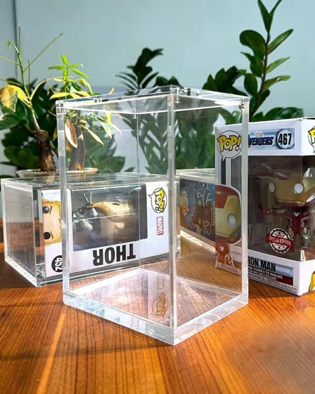 VaultifyUK premium clear acrylic display case for Funko Pop figures with a magnetic lid on a wooden table.