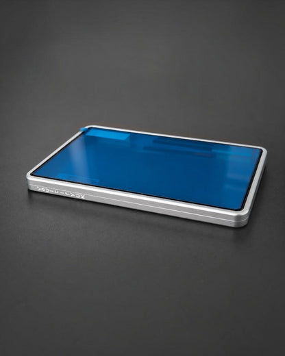 VaultifyUK Showcase aluminium BGS slab display case with a silver frame and protective blue film on a dark surface.