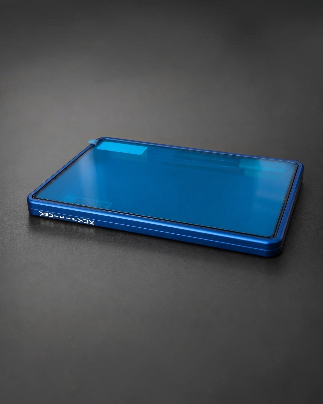 VaultifyUK Showcase blue aluminium display case for BGS graded cards with a clear viewing panel on a dark surface.