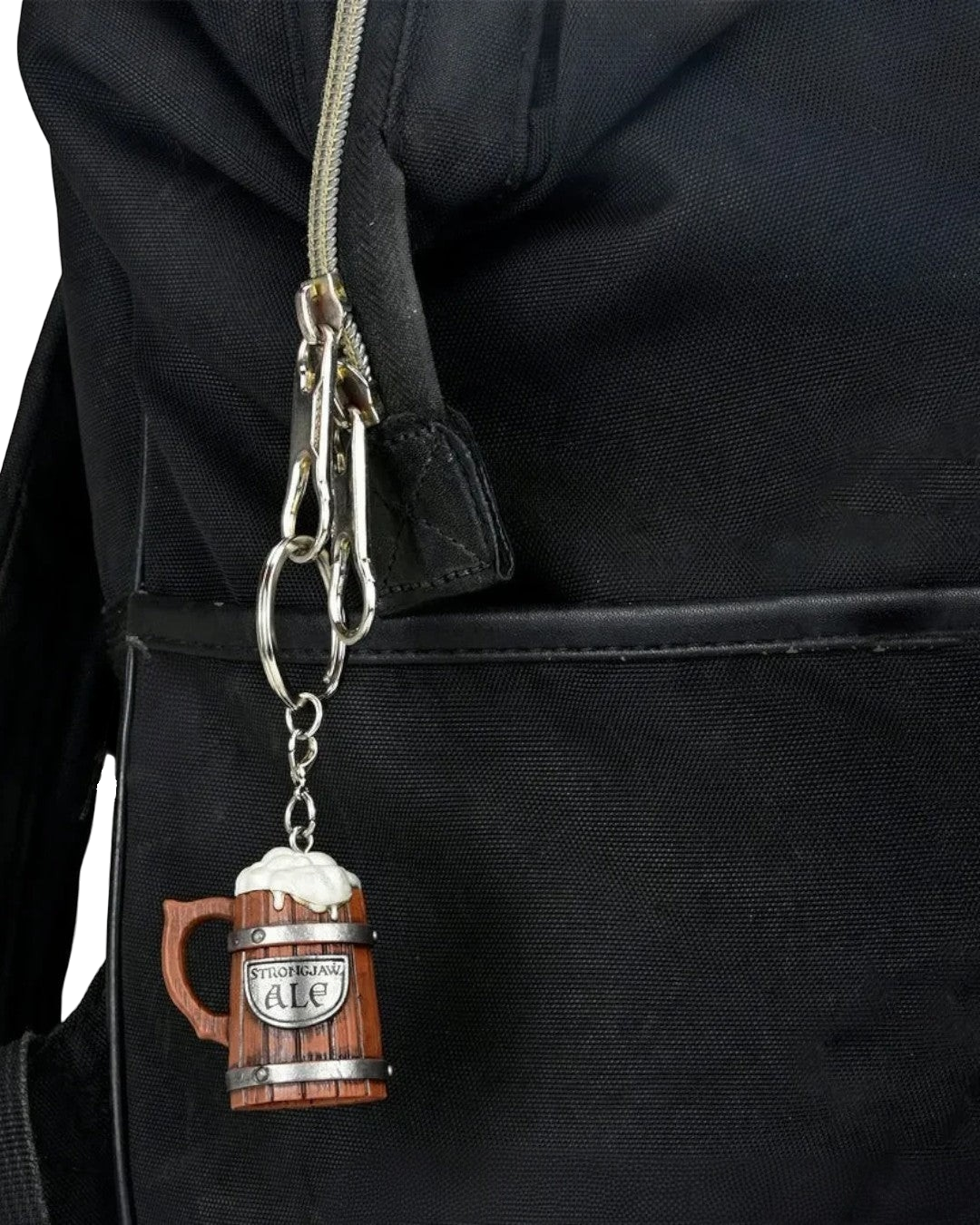 VaultifyUK Critical Role Strongjaw Ale tankard charm attached to a black backpack zipper