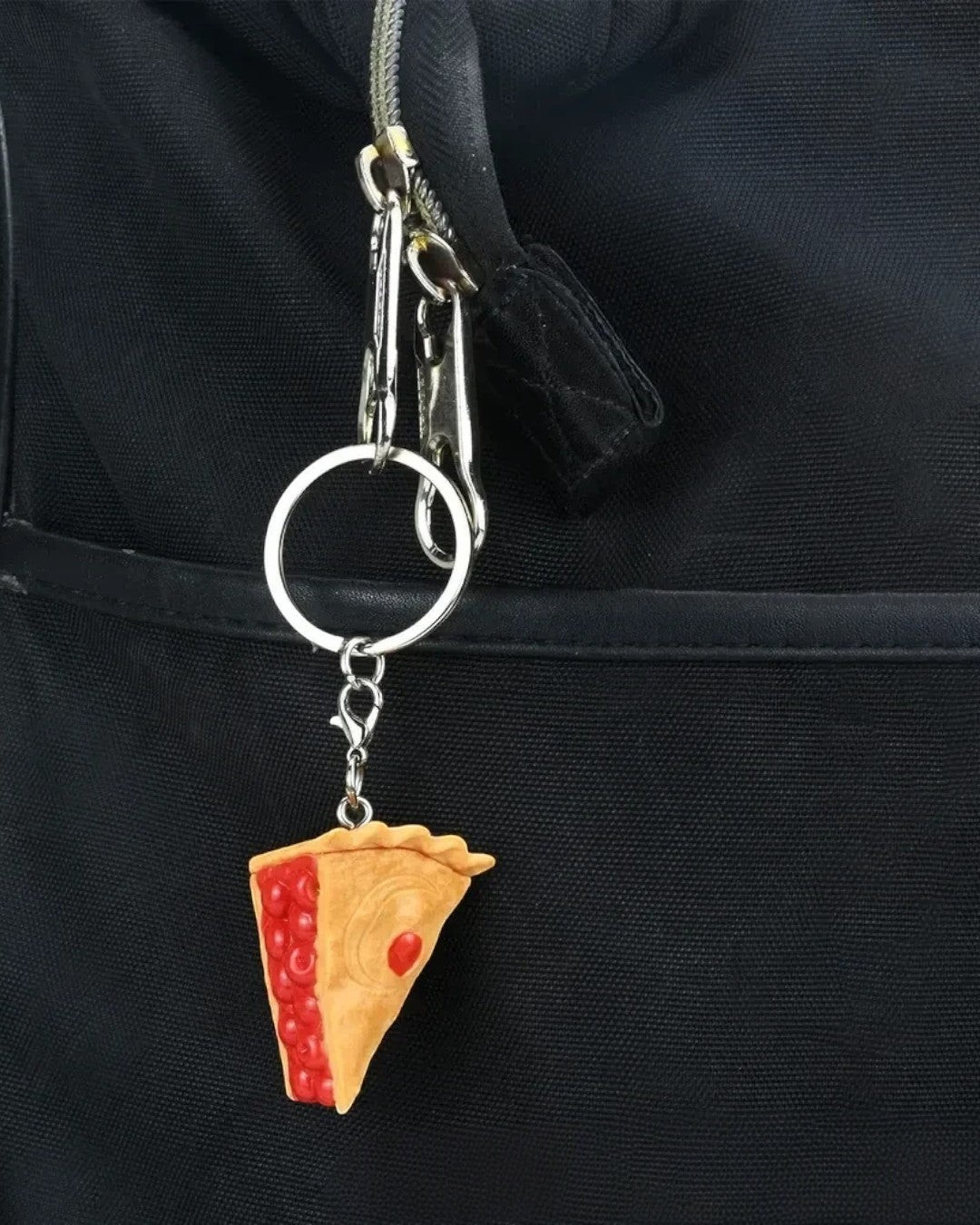 VaultifyUK Critical Role Taste of Exandria cherry pie food charm attached to a black backpack keyring