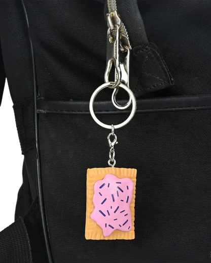 VaultifyUK Critical Role Taste of Exandria charm featuring a pink frosted pastry design attached to a black bag