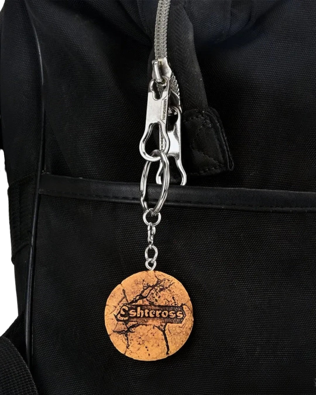 VaultifyUK Critical Role Taste of Exandria Tusktooth Cookie charm attached to a black bag zipper