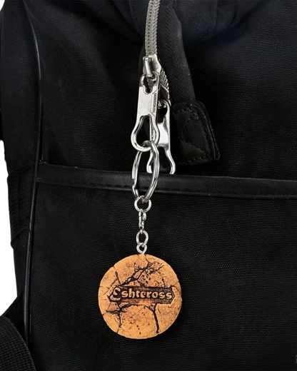VaultifyUK Critical Role Taste of Exandria Tusktooth Cookie charm attached to a black bag zipper