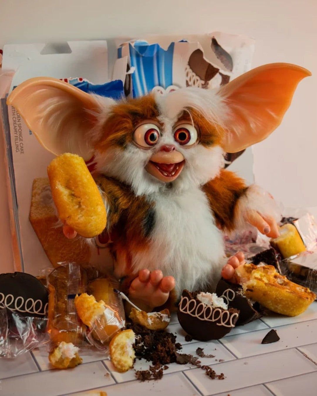 VaultifyUK 1:1 scale Daffy Mogwai prop from Gremlins 2 with orange and white faux fur, wide eyes, and snack debris.