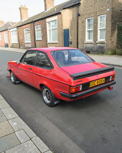 The real Ford Escort Mk2 RS2000: rear three-quarter view of a red RS2000 showing its rear spoiler (not the exact car Corgi modelled)