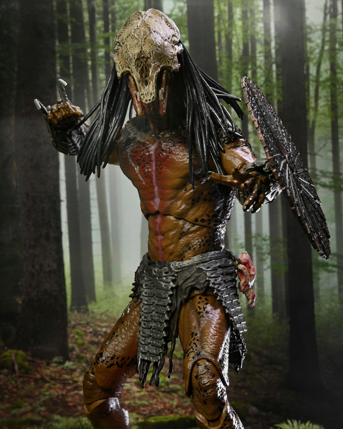 VaultifyUK NECA Prey Feral Predator 7-inch action figure with bone mask, detailed armour, and forest background