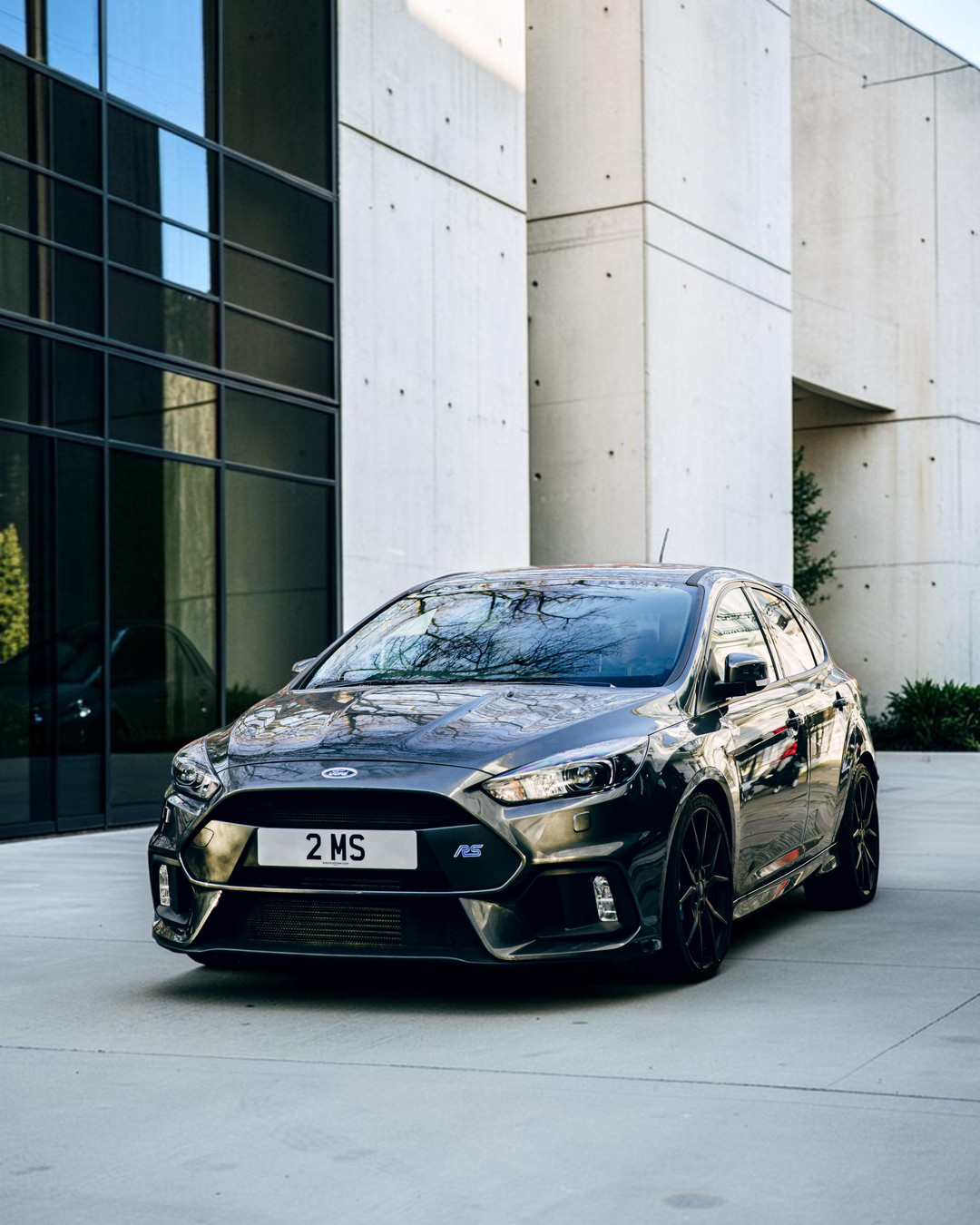 The real Ford Focus Mk3 RS: a dark Focus RS on black wheels parked on a London street, front three-quarter view (not the exact car Corgi modelled)