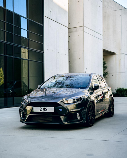 The real Ford Focus Mk3 RS: a dark Focus RS on black wheels parked on a London street, front three-quarter view (not the exact car Corgi modelled)