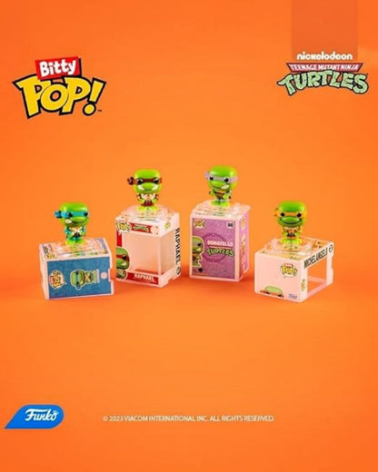 VaultifyUK Funko Bitty Pop TMNT mini figures featuring Raphael and Donatello in clear display cases on orange background