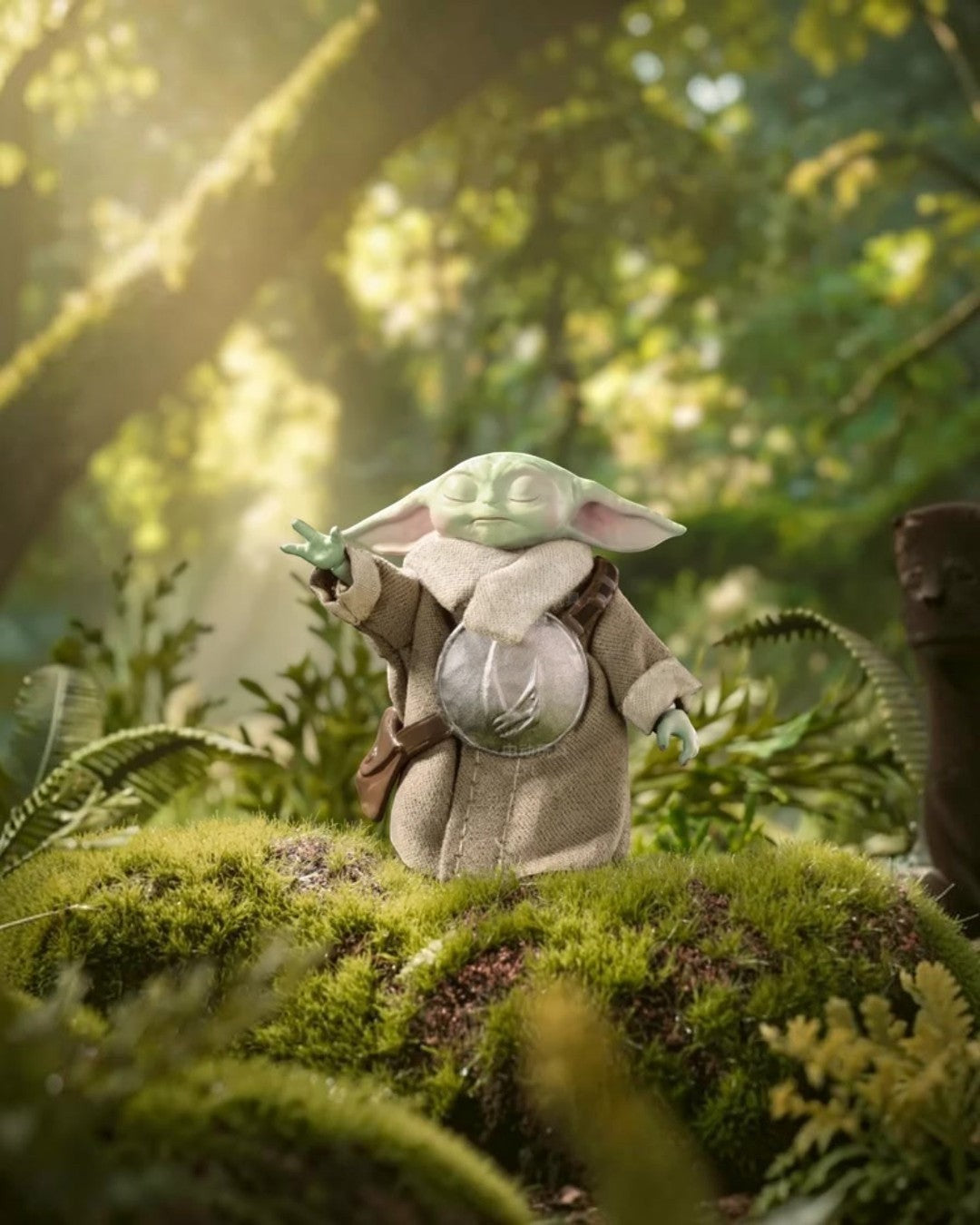 VaultifyUK ZD Toys Grogu figure from The Mandalorian standing on a mossy forest floor with a hand raised in the Force