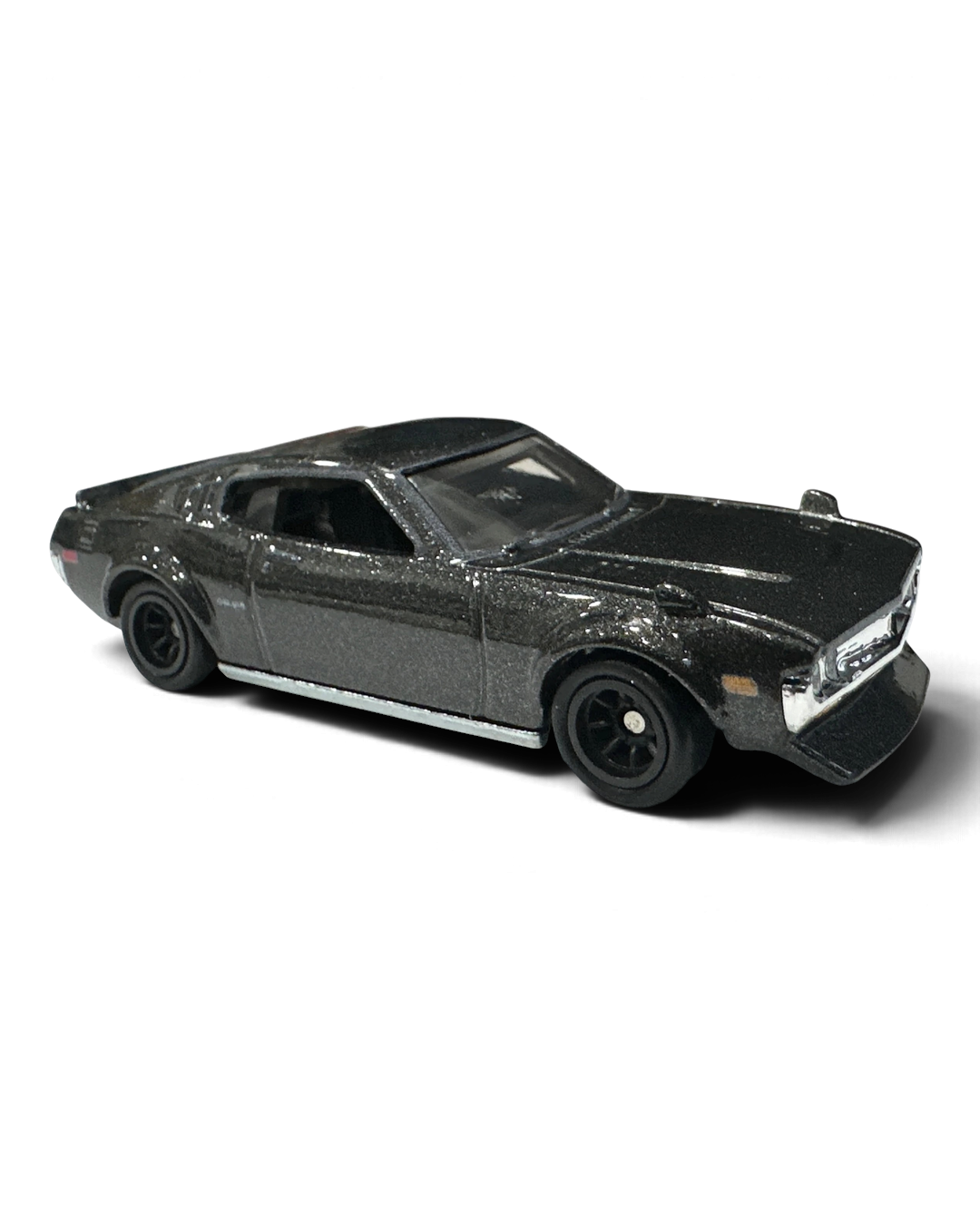 VaultifyUK Hot Wheels 1977 Toyota Celica die-cast car in black with rear louvres and black Real Riders wheels.