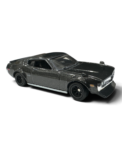 VaultifyUK Hot Wheels 1977 Toyota Celica die-cast car in black with rear louvres and black Real Riders wheels.