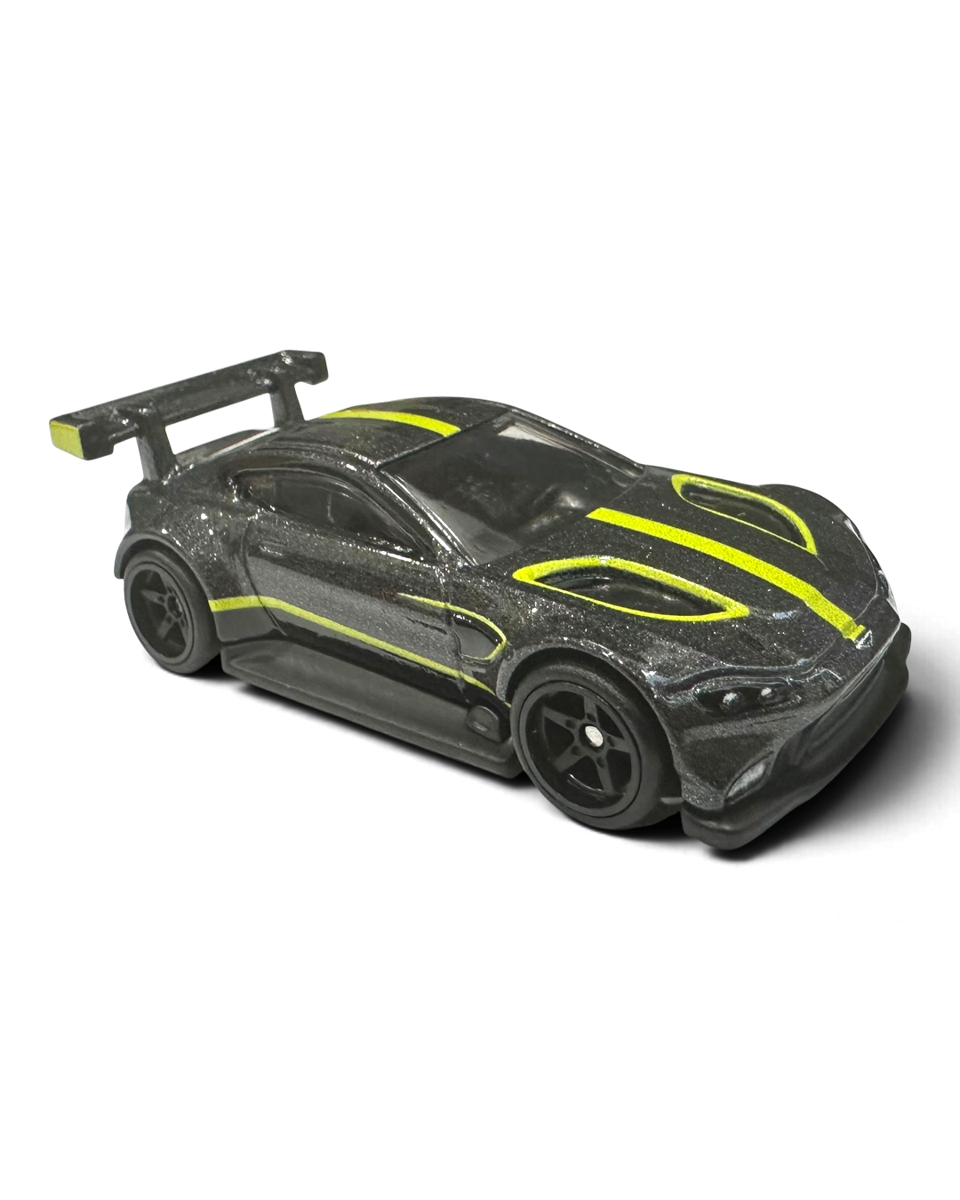 VaultifyUK Hot Wheels Aston Martin Vantage GTE die-cast car in dark grey with lime-green racing stripes and rear wing.