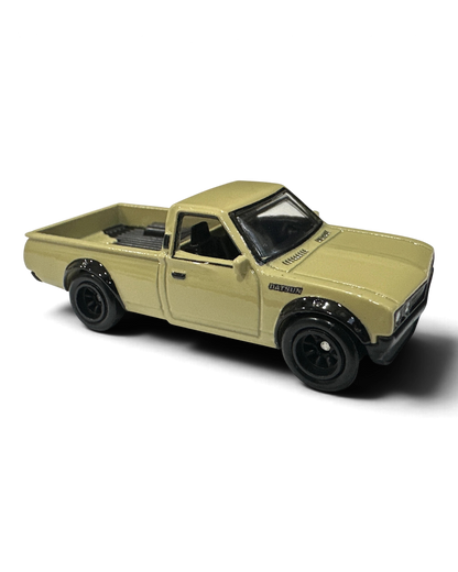 VaultifyUK Hot Wheels Datsun 620 die-cast truck in cream with black over-fenders and Real Riders wheels.