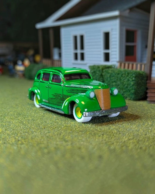 VaultifyUK Hot Wheels Premium DC Action Comics sedan in green with comic-inspired details and white-wall Real Riders