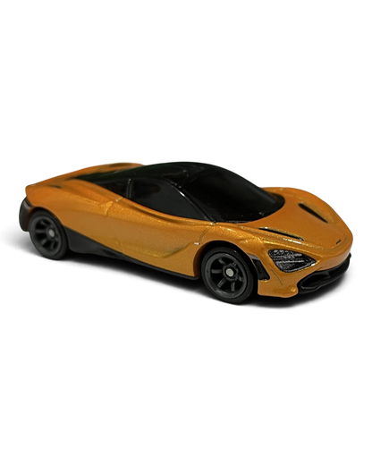 VaultifyUK Hot Wheels Premium McLaren 720S die-cast car in metallic orange with black trim and dark grey wheels.
