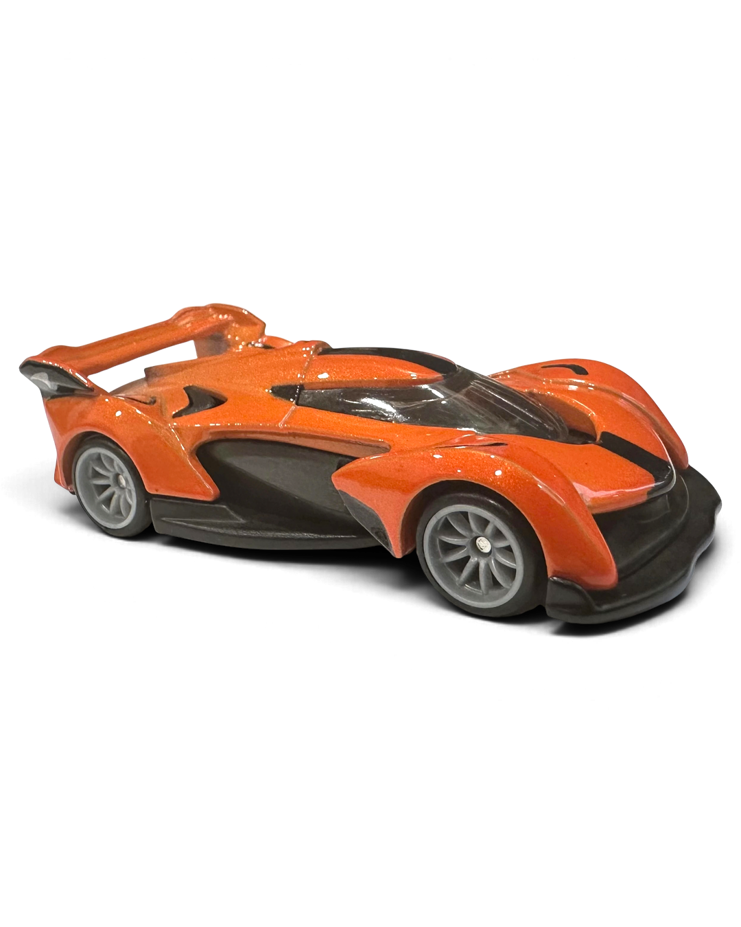 VaultifyUK Hot Wheels Premium McLaren Solus GT die-cast car in bright orange with silver wheels and black aero details.