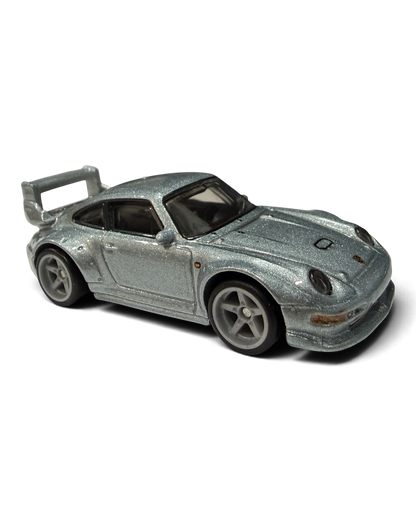 VaultifyUK Hot Wheels Premium Porsche 993 GT2 die-cast car in metallic silver with rear wing and Real Riders tires.