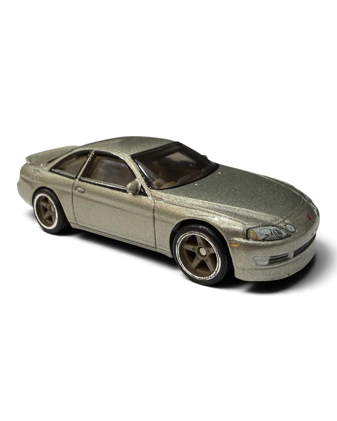 VaultifyUK Hot Wheels Toyota Soarer die-cast car in metallic gold with silver five-spoke wheels and realistic tires.