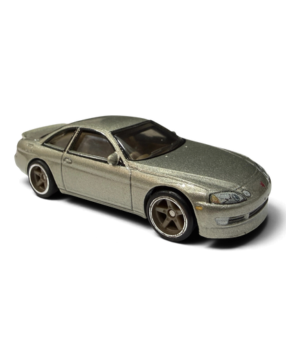VaultifyUK Hot Wheels Toyota Soarer die-cast car in metallic gold with silver five-spoke wheels and realistic tires.