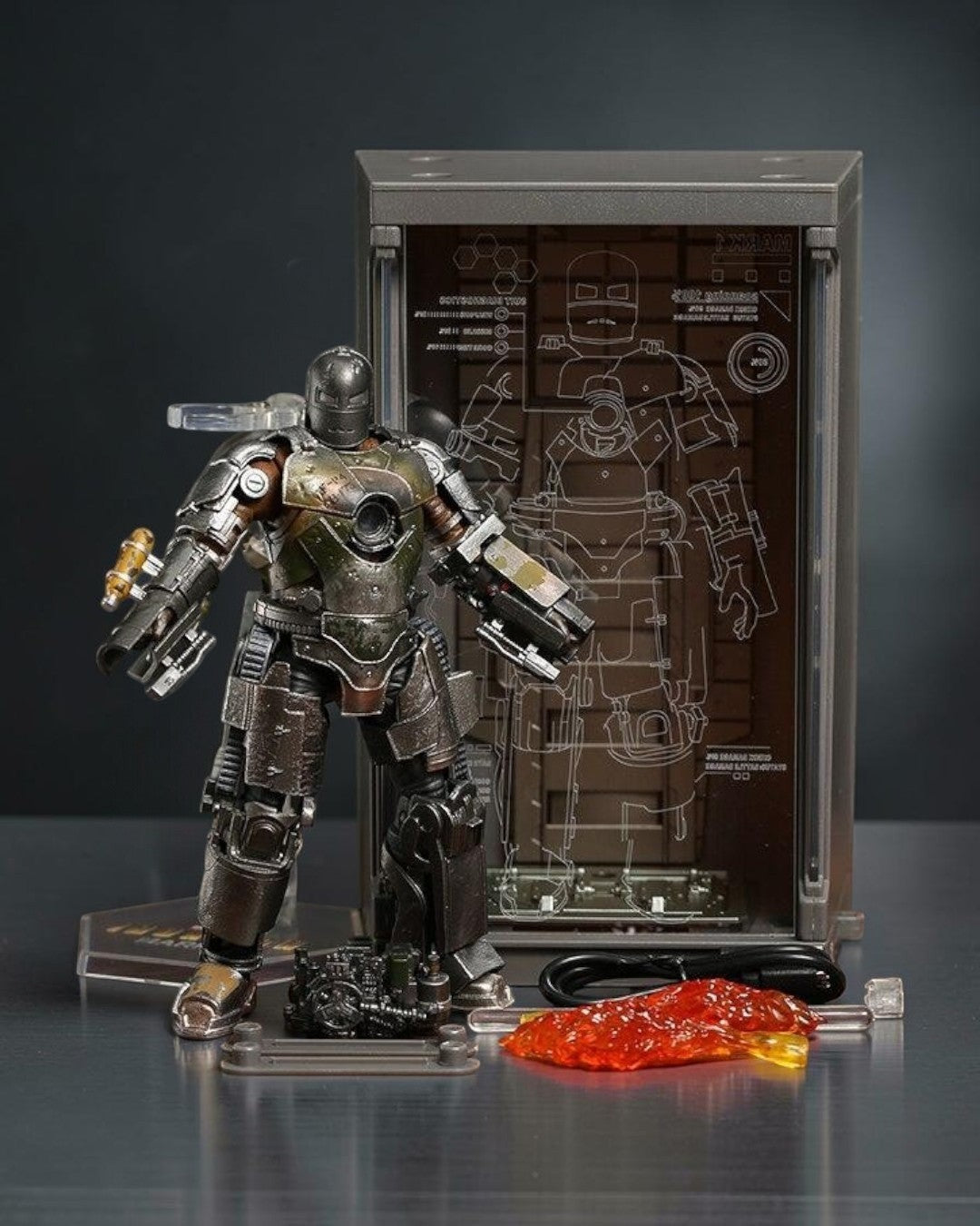 VaultifyUK Iron Man Mark I 1/10 scale figure with weathered metal finish, displayed in an illuminated Hall of Armor.