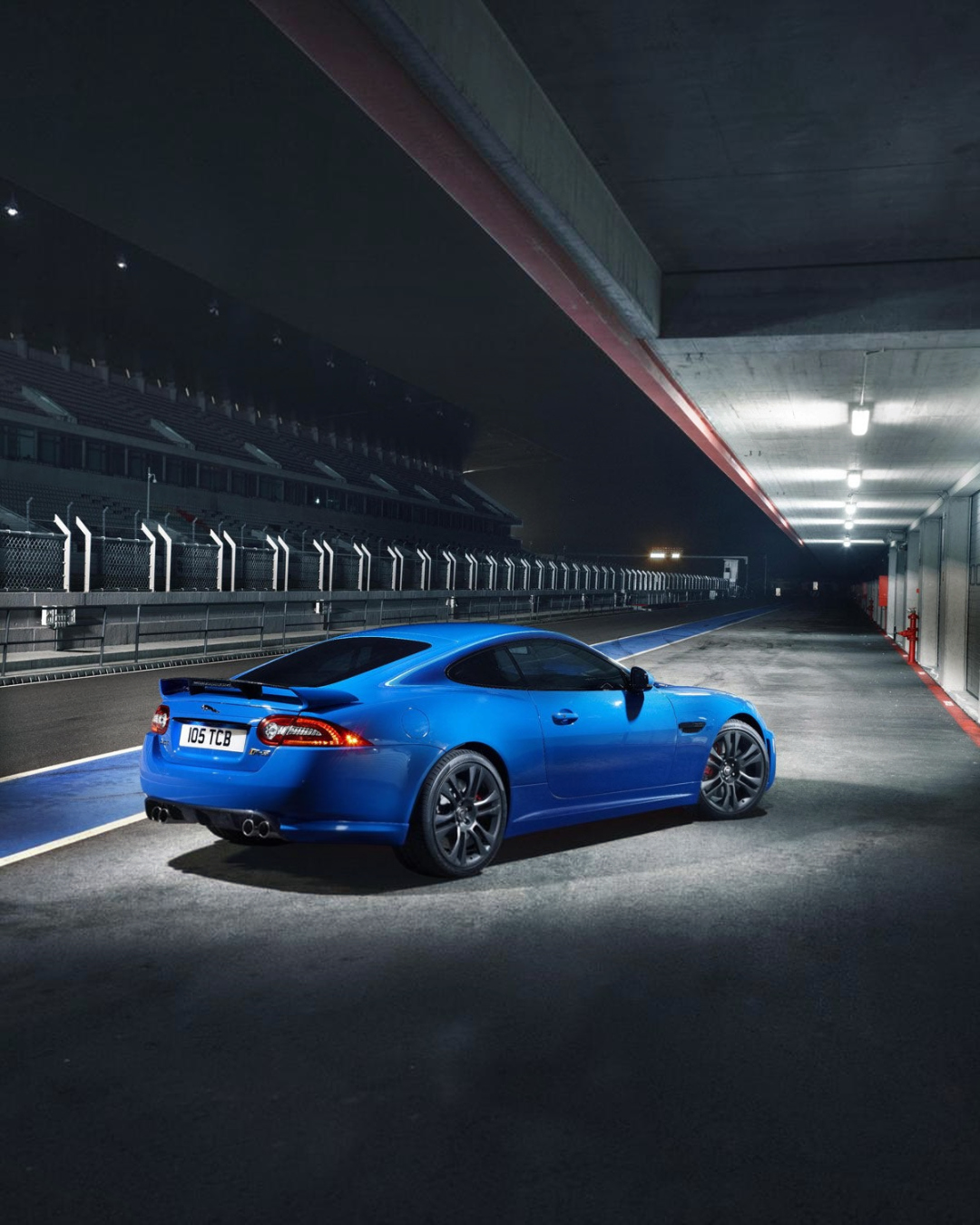VaultifyUK 1:43 scale Jaguar XKR-S model car in French Racing Blue with black wheels and rear spoiler on a track