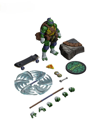 VaultifyUK JoyToy Donatello 1/18 scale action figure with bo staff, skateboard, pizza slice, and interchangeable hands.