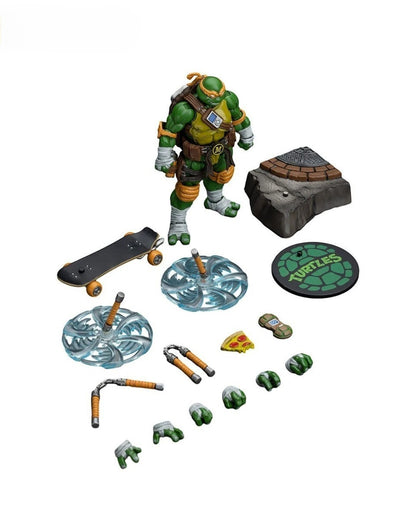 VaultifyUK JoyToy Michelangelo action figure with nunchaku, skateboard, pizza slice, and display base accessories.