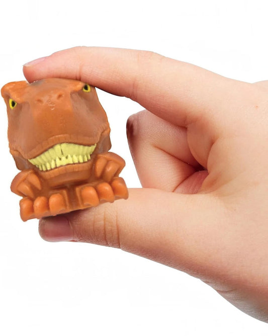 VaultifyUK Jurassic World MASH'EMS Series 2 squishy brown T-Rex dinosaur figure being squeezed by a hand