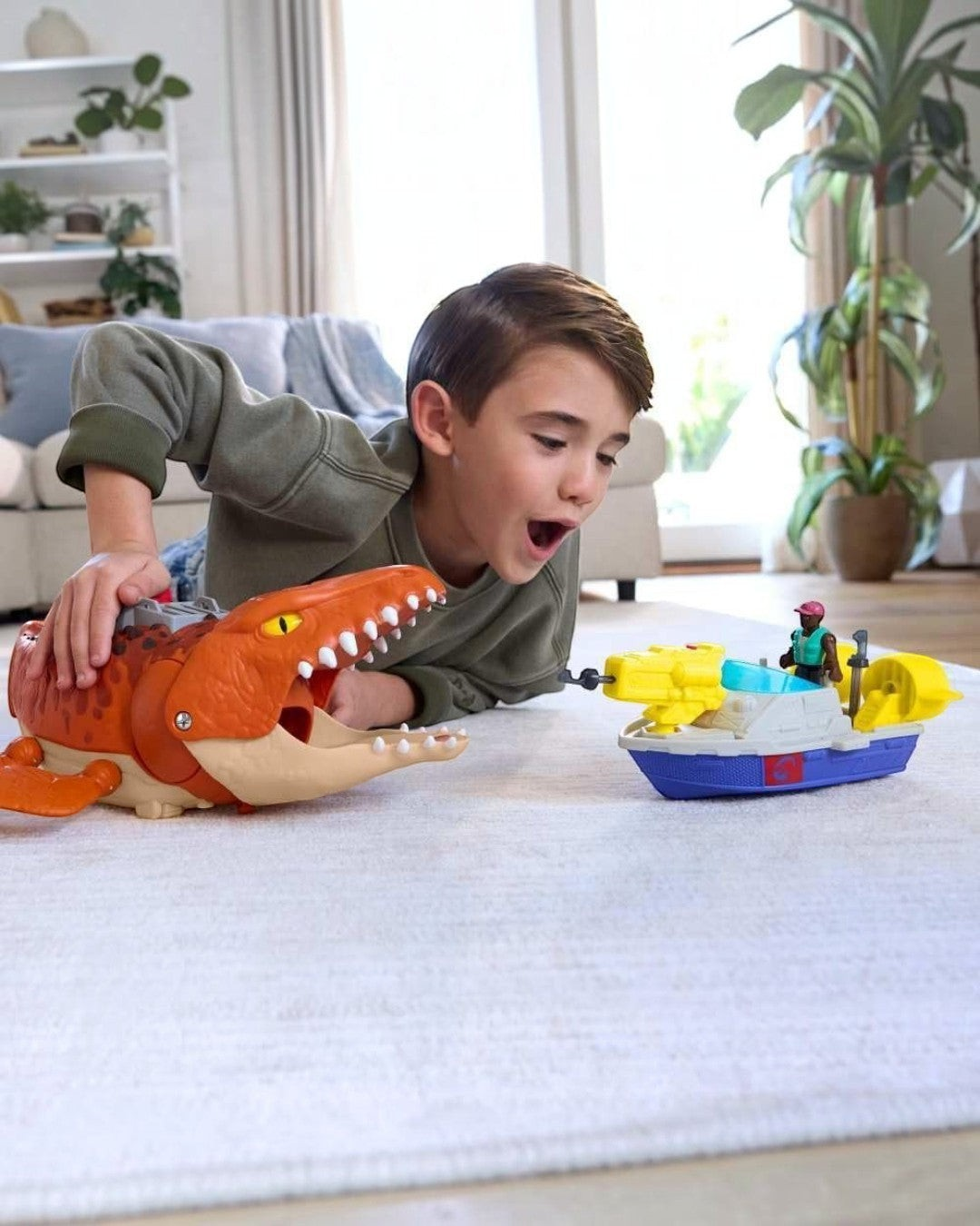 VaultifyUK Jurassic World Rebirth Mosasaurus playset with boy playing with the dinosaur and rescue boat on a rug