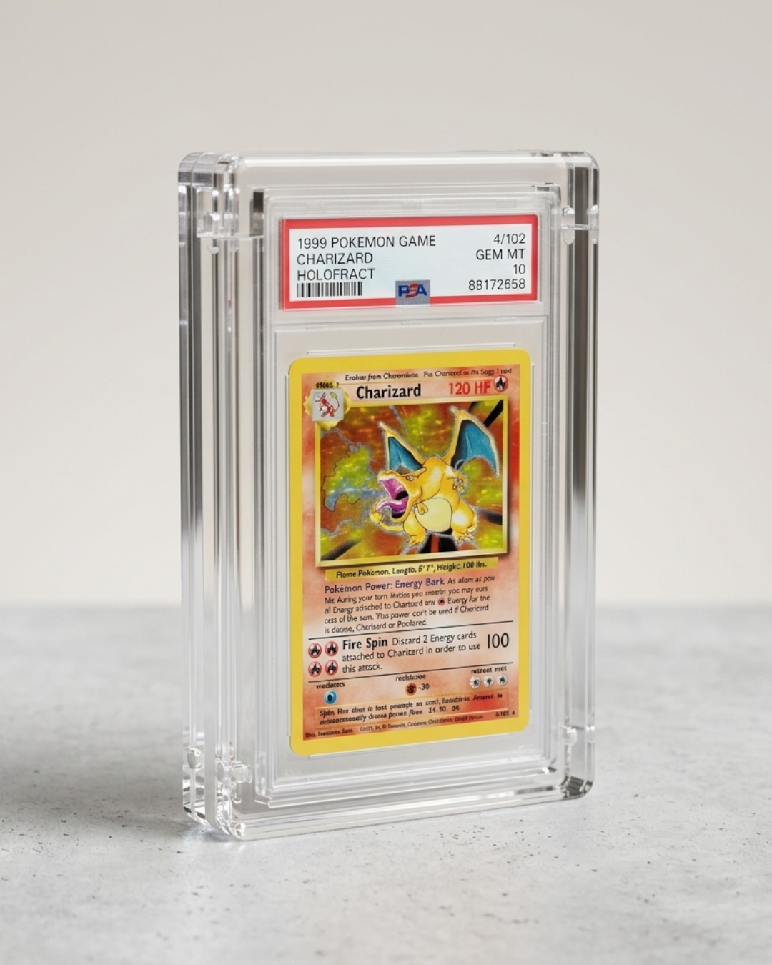 VaultifyUK magnetic clear acrylic display case holding a PSA graded Charizard Pokemon card on a grey surface