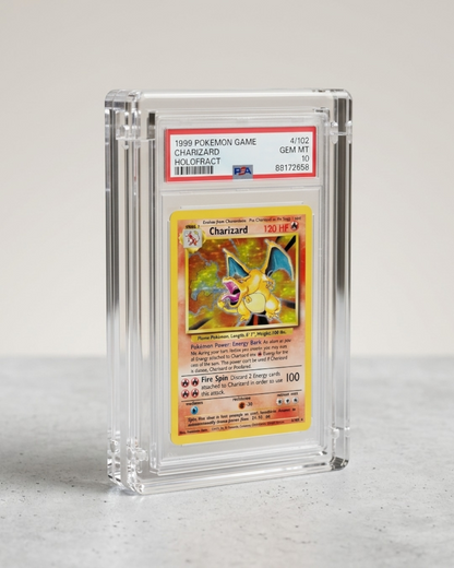 VaultifyUK magnetic clear acrylic display case holding a PSA graded Charizard Pokemon card on a grey surface