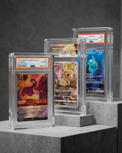 VaultifyUK Showcase magnetic acrylic display cases holding PSA graded trading cards on a grey concrete display stand.