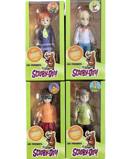 VaultifyUK Mezco Living Dead Dolls Scooby-Doo collector set featuring Daphne, Fred, Velma, and Shaggy in display boxes